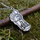 Silver Bigfoot Necklace with Alien Buddy Pendant on a branch